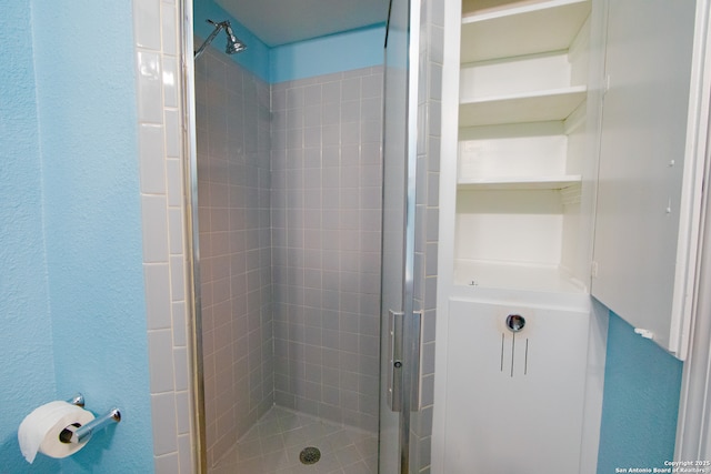 full bathroom with a stall shower and a textured wall
