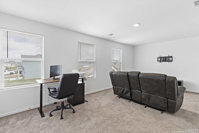 carpeted office with healthy amount of natural light and baseboards