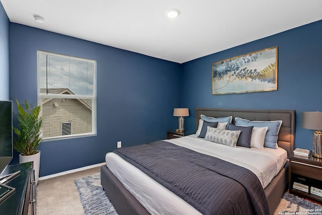 carpeted bedroom with baseboards