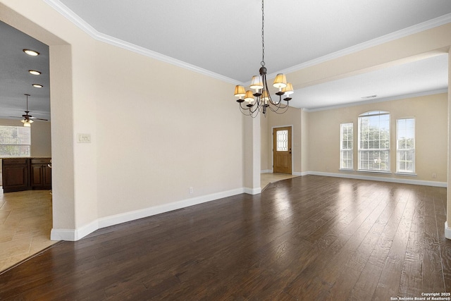 unfurnished room with plenty of natural light, a chandelier, crown molding, and hardwood / wood-style floors