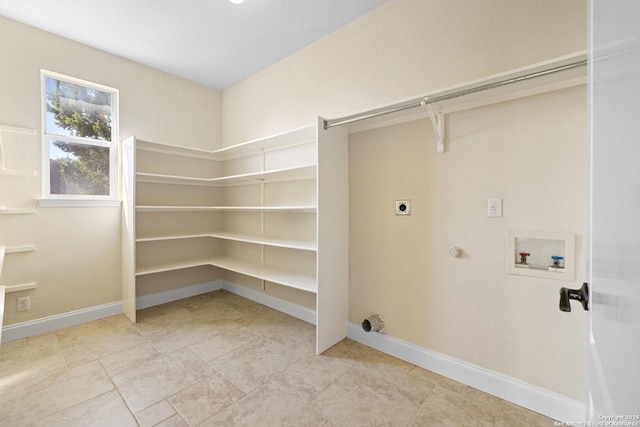 laundry area with hookup for an electric dryer, washer hookup, baseboards, and gas dryer hookup
