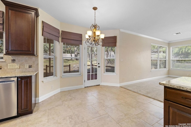 unfurnished dining area with a chandelier, baseboards, and ornamental molding