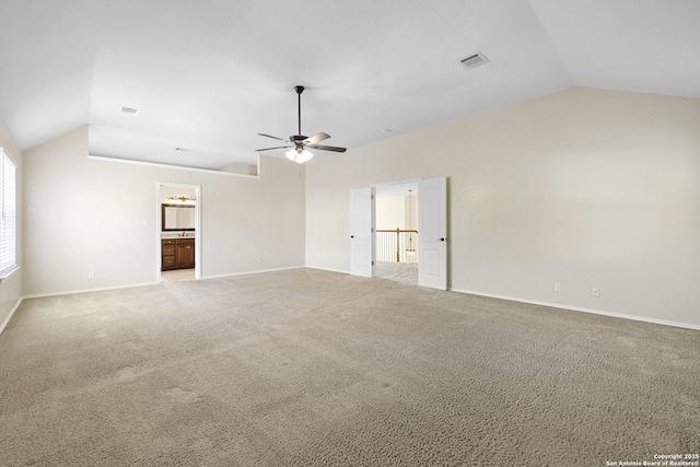 unfurnished living room featuring vaulted ceiling, a ceiling fan, carpet, and baseboards