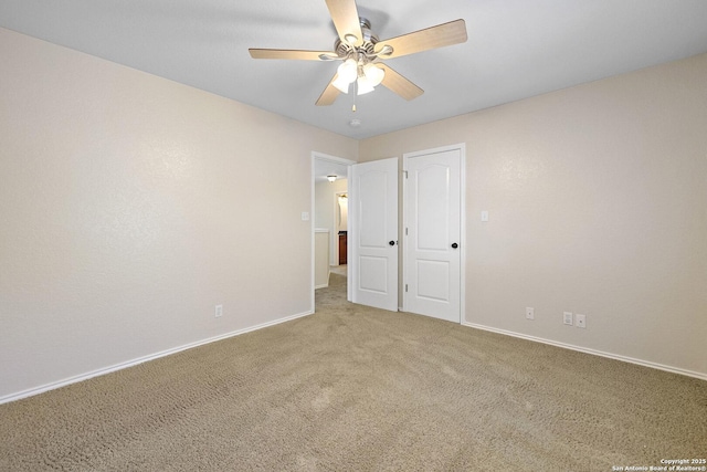 unfurnished bedroom with light carpet, baseboards, and ceiling fan
