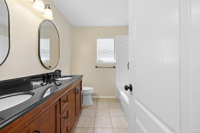 full bathroom featuring double vanity, toilet, tile patterned floors, and baseboards