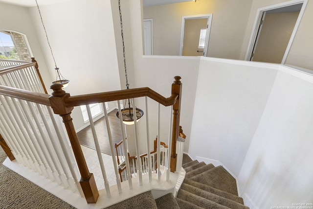 stairs featuring carpet flooring and baseboards