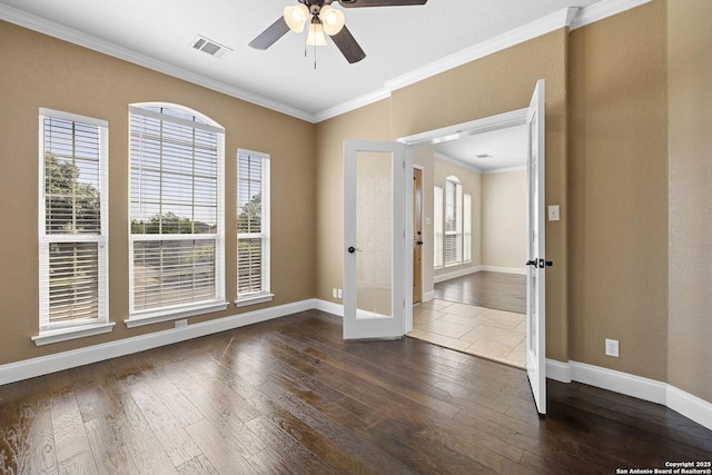 unfurnished room with french doors, crown molding, ceiling fan, dark wood finished floors, and baseboards