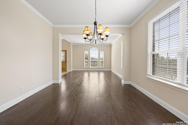 unfurnished dining area with a chandelier, dark wood finished floors, baseboards, and crown molding