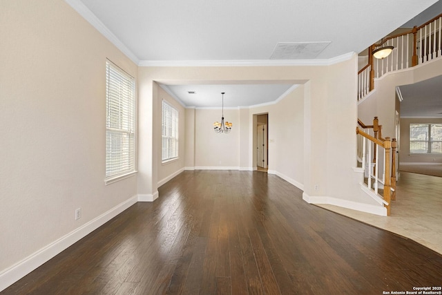 unfurnished living room with stairs, a chandelier, wood-type flooring, ornamental molding, and baseboards