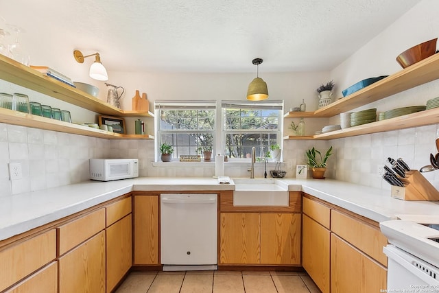 kitchen featuring open shelves, white appliances, a sink, backsplash, and a textured ceiling
