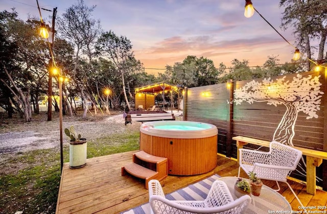 dock area with a hot tub and a deck