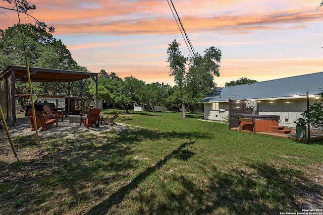 view of grassy yard featuring a hot tub