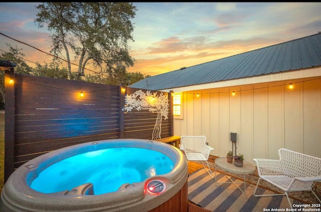 view of swimming pool with a hot tub