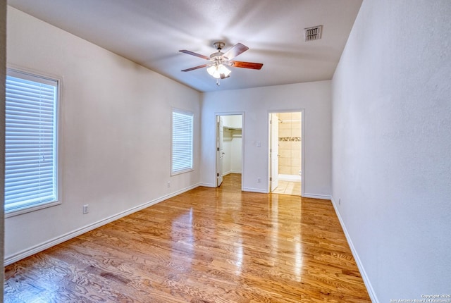 120 W Brazos, Uvalde, TX 78801 - unfurnished room featuring wood finished floors, a ceiling fan, and plenty of natural light