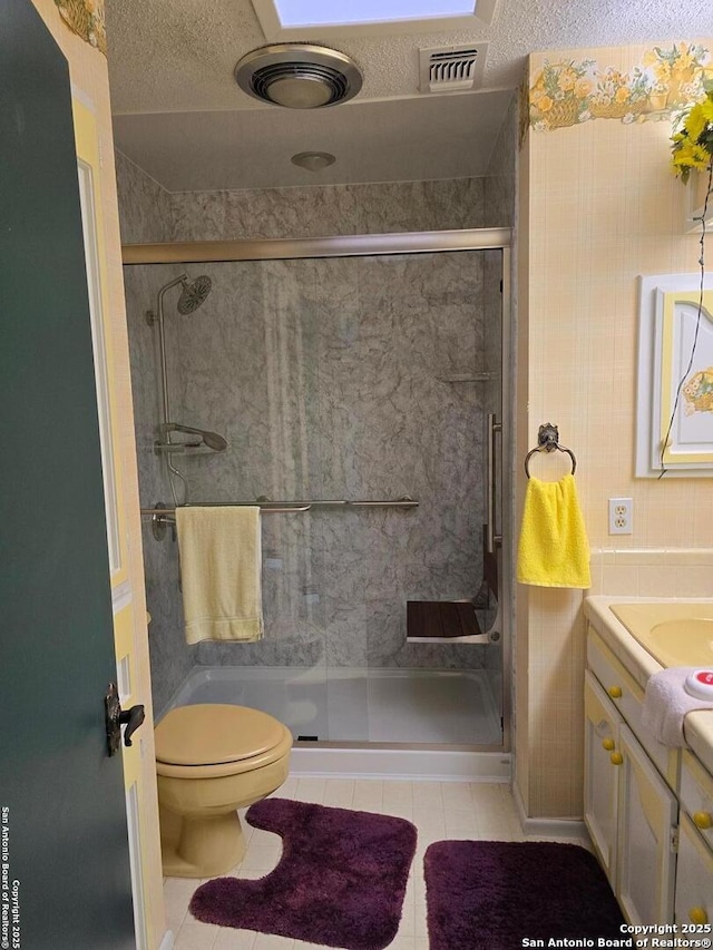9840 Tower Vw, Helotes, TX 78023 - full bath featuring tile patterned floors, a shower stall, vanity, and toilet