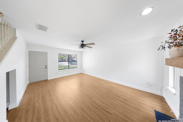 8201 Bluff Bnd, San Antonio, TX 78250 - unfurnished living room with light wood-type flooring, a fireplace, a ceiling fan, and baseboards