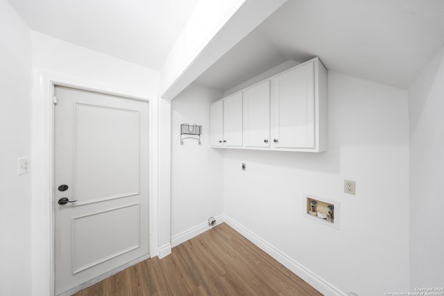 8201 Bluff Bnd, San Antonio, TX 78250 - laundry room with electric dryer hookup, washer hookup, wood finished floors, baseboards, and cabinet space