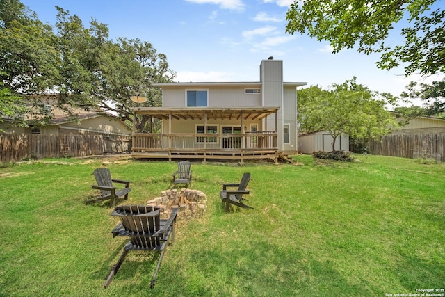 8201 Bluff Bnd, San Antonio, TX 78250 - rear view of property with an outdoor fire pit, a shed, a chimney, a wooden deck, and an outdoor structure