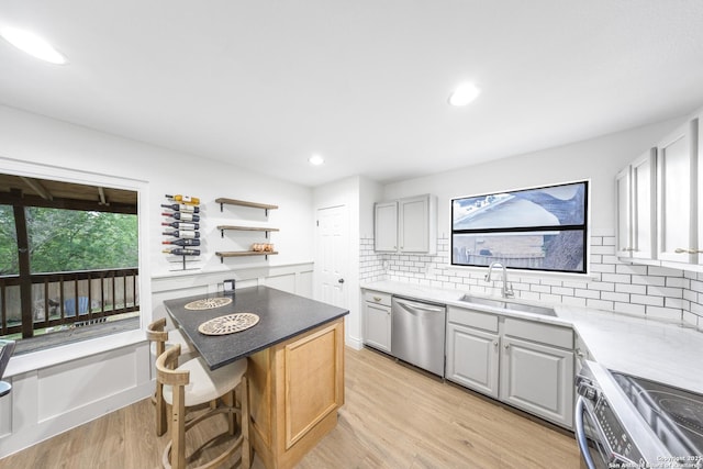 8201 Bluff Bnd, San Antonio, TX 78250 - kitchen with stainless steel appliances, a sink, decorative backsplash, light wood finished floors, and open shelves