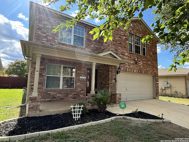 view of front facade with covered porch, a garage, brick siding, and driveway