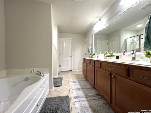 full bath with tile patterned floors, double vanity, a garden tub, a shower stall, and baseboards