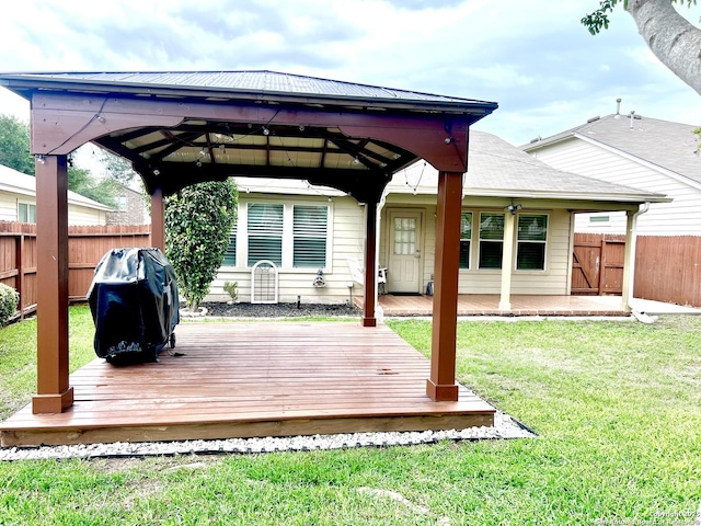 wooden terrace with a gazebo and a grill