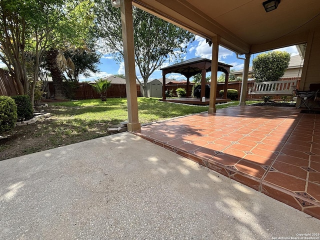 view of patio with a gazebo, an outdoor structure, and a storage shed