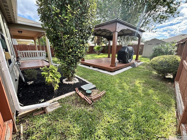 view of yard featuring a deck and a shed