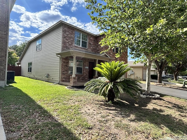 view of front of house featuring brick siding and central AC