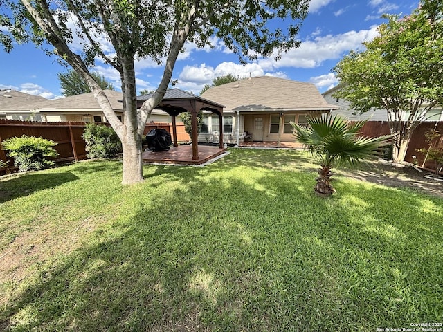 rear view of property featuring a gazebo