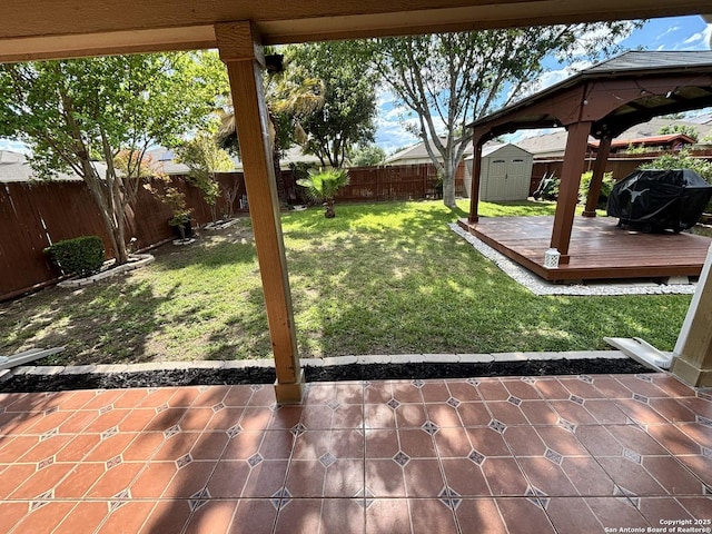 view of yard featuring a storage shed, a deck, a gazebo, an outbuilding, and a patio