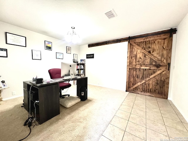 tiled office featuring a barn door and carpet