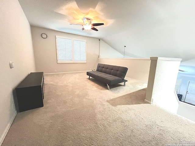 sitting room with carpet, ceiling fan, healthy amount of natural light, baseboards, and vaulted ceiling