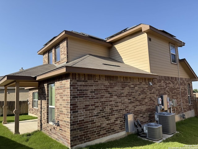 15319 Comanche, San Antonio, TX 78233 - view of home's exterior with cooling unit, brick siding, and a patio