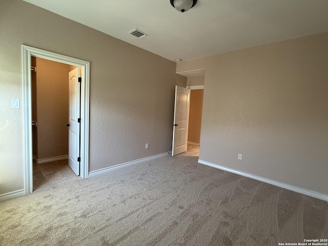 15319 Comanche, San Antonio, TX 78233 - unfurnished bedroom featuring carpet, baseboards, and a walk in closet