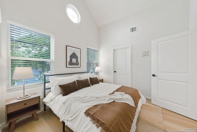1102 S Gevers St, San Antonio, TX 78210 - bedroom with high vaulted ceiling and light wood-style floors