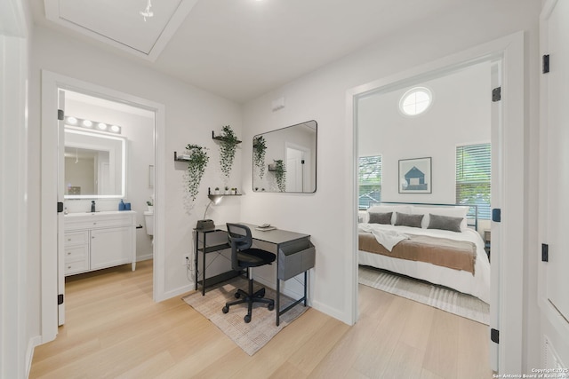 1102 S Gevers St, San Antonio, TX 78210 - bedroom with light wood-type flooring, a sink, connected bathroom, and baseboards