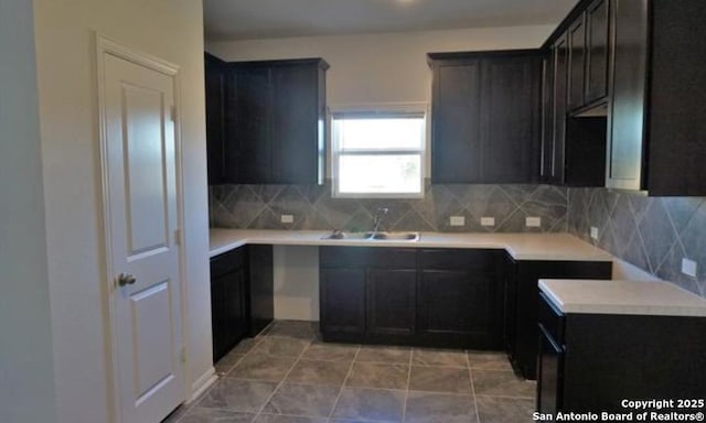 7374 Braes Cor, San Antonio, TX 78244 - kitchen with a sink, decorative backsplash, light countertops, and light tile patterned floors