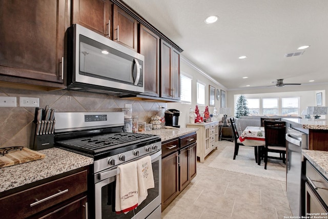 13227 Cache Crk, San Antonio, TX 78253 - kitchen featuring appliances with stainless steel finishes, tasteful backsplash, dark brown cabinets, recessed lighting, and light stone counters