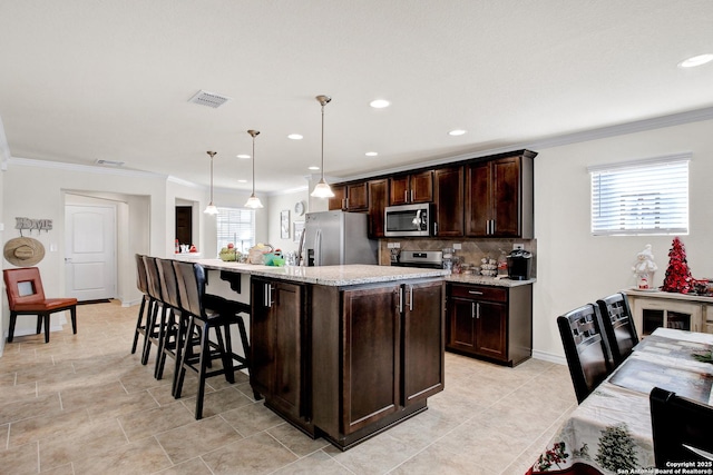 13227 Cache Crk, San Antonio, TX 78253 - kitchen with stainless steel appliances, dark brown cabinets, decorative backsplash, ornamental molding, and decorative light fixtures
