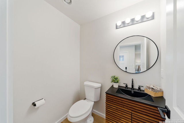 1108 S Gevers St, San Antonio, TX 78203 - bathroom featuring toilet, vanity, baseboards, and wood finished floors