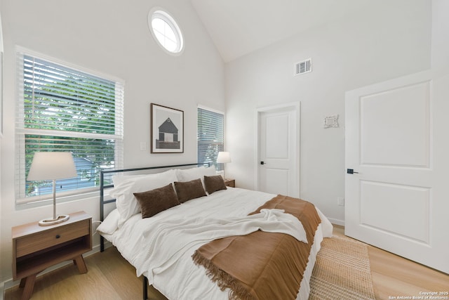1108 S Gevers St, San Antonio, TX 78203 - bedroom with high vaulted ceiling and light wood-style floors