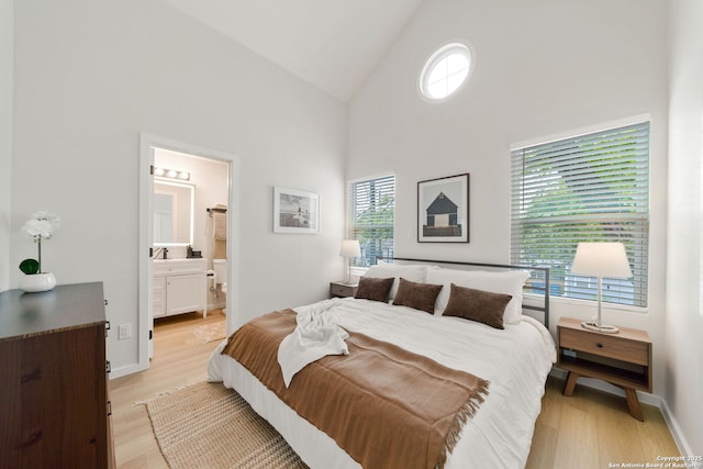 1108 S Gevers St, San Antonio, TX 78203 - bedroom featuring light wood-style flooring, high vaulted ceiling, a sink, and ensuite bath
