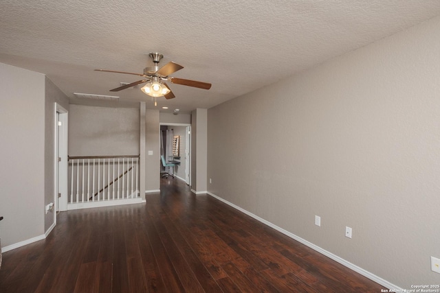 1026 Dogleg Right, San Antonio, TX 78221 - spare room featuring ceiling fan, wood-type flooring, baseboards, and a textured ceiling