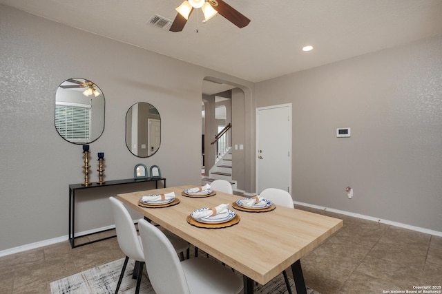 1026 Dogleg Right, San Antonio, TX 78221 - dining area featuring ceiling fan, arched walkways, stairs, and baseboards