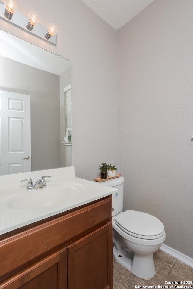 1026 Dogleg Right, San Antonio, TX 78221 - half bathroom with tile patterned flooring, toilet, vanity, and baseboards