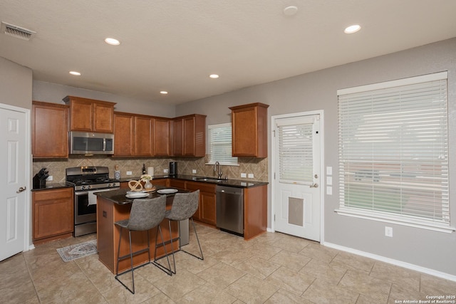 1026 Dogleg Right, San Antonio, TX 78221 - kitchen with appliances with stainless steel finishes, a sink, decorative backsplash, dark countertops, and recessed lighting