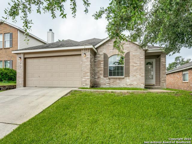 1818 Vinca Mnr, San Antonio, TX 78260 - ranch-style house featuring an attached garage, brick siding, concrete driveway, a front yard, and a chimney