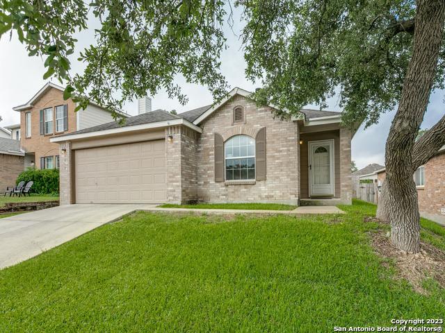 1818 Vinca Mnr, San Antonio, TX 78260 - ranch-style home with a garage, a front lawn, brick siding, and concrete driveway