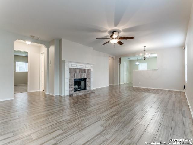 1818 Vinca Mnr, San Antonio, TX 78260 - unfurnished living room with ceiling fan, light wood-type flooring, a fireplace, and baseboards